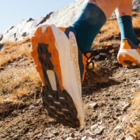 Laspo-Lugs: 4 mm, stärkere Stollen an der Ferse für Bremswirkung und Halt beim Aufsetzen der Ferse; Breiterer Vorfuß: größere Aufstandsfläche im Zehenbereich für mehr Stabilität und Halt; Flow-Film auf der Außensohle: Erhält die Rocker-Form, verhindert Verformungen und sorgt für einen geschmeidigen Schritt